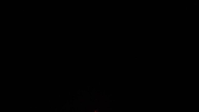 Fireworks shooting through smoke from the previous exploded fireworks. Captured by a drone.
