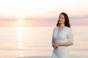 Portrait of a mature woman by the sea at sunset