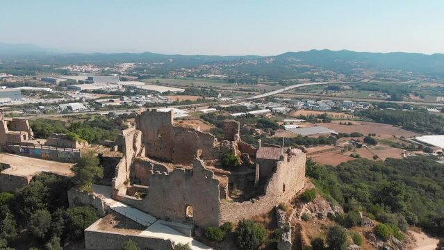 falling aerial of Castell de Palafolls near Barcelona, Spain. Cataluña offers a cultural experience like no other.  History and great fine cuisine define the Cataluna region and countryside