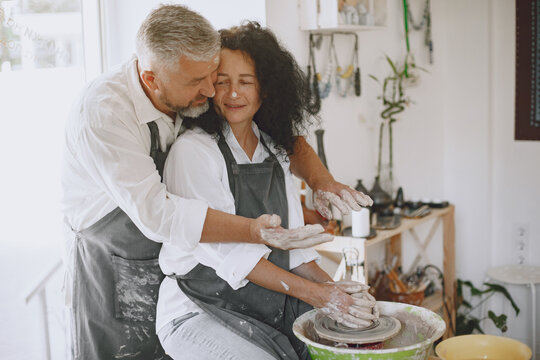 Adult senior couple at artwork in pottery