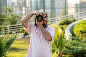 photographer in hat at park with camera professional guy on the photoshoot seizing moment