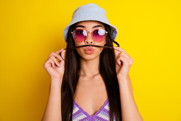 Portrait of cute charming female with fake mustache fooling around flirting with boyfriend isolated on yellow color background