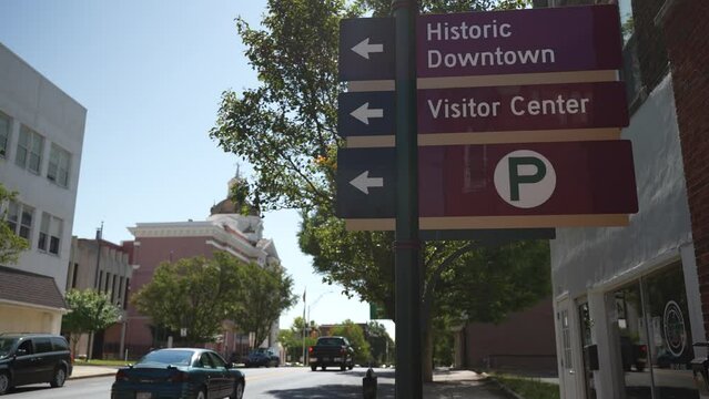 Sign for historic downtown Martinsburg, West Virginia, WV with Berkeley County courthouse in background.