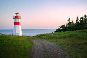 Foto op Plexiglas Atlantische weg The beautiful Musquash head lighthouse at dusk, that overlook the coast over bay of fundy, St-John, New Brunswick, Canada