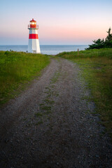 The beautiful Musquash head lighthouse at dusk, that overlook the coast over bay of fundy, St-John,...