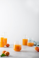 Summer apricot juice on the light background