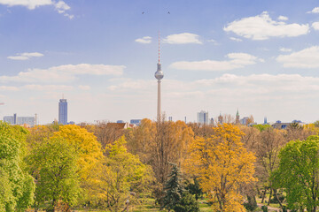 Summer turns to Autumn in Berlin, a view above the trees of the skyline with the Berliner...