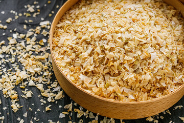 dried onions on a black wooden rustic background