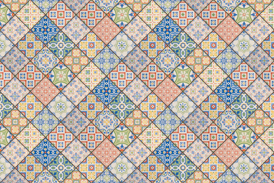 Old colorful seamless flowers leaves vintage geometric shabby mosaic ornate patchwork motif porcelain stoneware tiles, square mosaic stone concrete cement tile  wall texture background, 45 degrees.