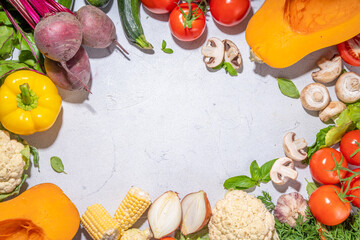 Autumn vegetables cooking background. Organic fall harvest farm vegetables, mushrooms. Various vegetarian ingredients set for cooking dinner on white kitchen background, top view copy space