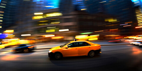 Fototapeta na wymiar Taxi at Night in Busy City Street Dark Fast Driving Transportation