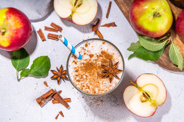 Apple pie smoothie with yogurt, apple slices, oatmeal granola flakes, cinnamon, spices and walnuts. Healthy uatumn breakfast or snack, with fresh raw apples and spices copy space