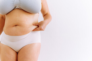 sagging skin with age spots on fat belly, plastic surgery concept