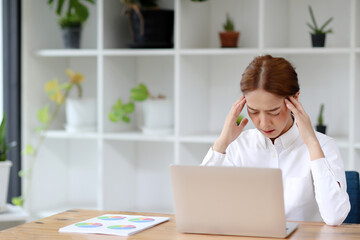 Fototapeta na wymiar Business Asian woman are stressed at work in the office. Asian beautiful woman feels uncomfortable working. Which is caused by stress, accumulated from unsuccessful work And less resting body.