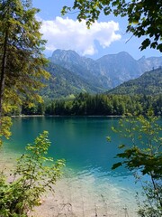Emerald lakes water with mountain view and fresh green leaves in Austria