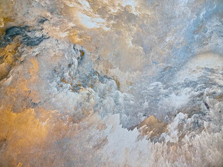 Spotted multi-colored background from decorative plaster with abstract spots. Unusual texture of this wall with beautiful patterns, creative surface background. Finishing coating for building cladding