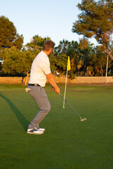 Fototapeta premium Golf ball on green grass ready to be struck at golf club, close up in golf course.