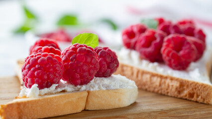 Toast with ripe raspberries close-up