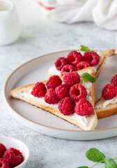Ricotta toast with fresh raspberries on a plate