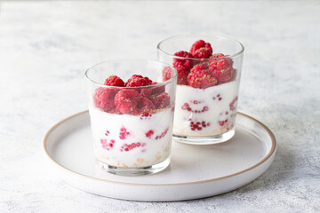 Raspberries and yogurt in a glass on the table