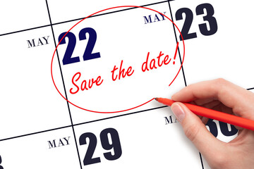 22nd day of May. Hand drawing red line and writing the text Save the date on calendar date May 22....