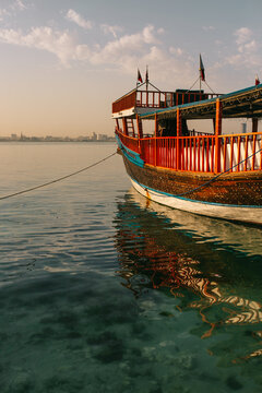 Boat moored in port at sunset