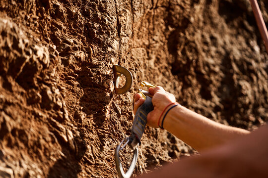 Cropped Hand Of Woman Attaching Carabiner On Hook