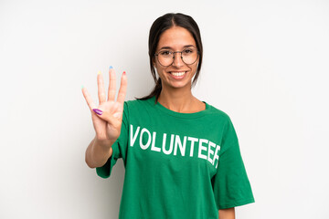 hispanic pretty woman smiling and looking friendly, showing number four. volunteer concept