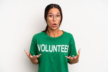 hispanic pretty woman amazed, shocked and astonished with an unbelievable surprise. volunteer...