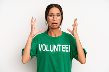 hispanic pretty woman screaming with hands up in the air. volunteer concept