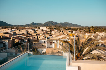 Swimming pool on rooftop of building in town under blue sky