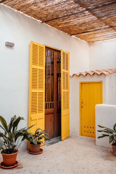 Facade of typical white house with yellow doors in Mallorca