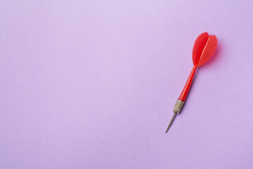 Red darts on color background, top view