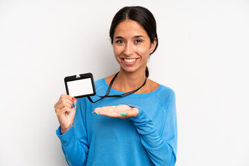 hispanic pretty woman smiling cheerfully, feeling happy and showing a concept. vip pass card id