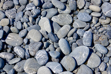 smooth black and gray pebbles on the beach