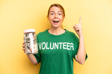 pretty blonde young woman feeling like a happy and excited genius after realizing an idea. donation...