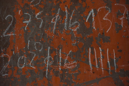 Digits on crumbling painted wall
