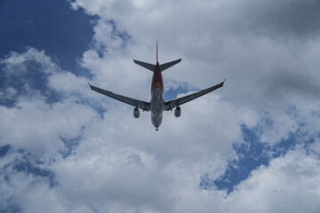 Passenger airplane flying in the blue sky.