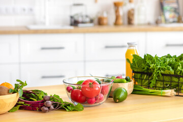 Kitchen table with various fresh vegetables for healthy and diet food with space for your product or text