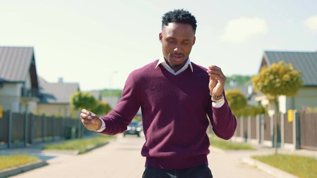 African american guy making body moves on street in slow motion. Smiling man dancing latino dance in countryside. Hot male dancer dancing outdoors.
