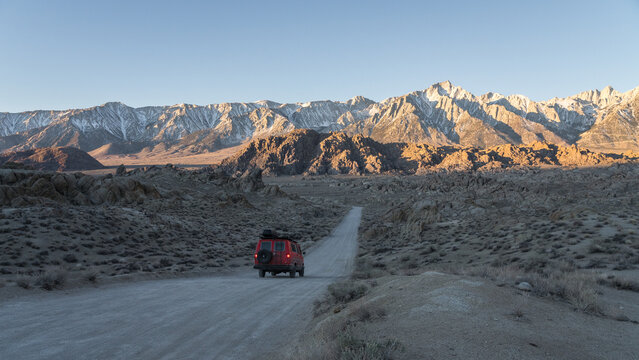 Van driving on road against mountains
