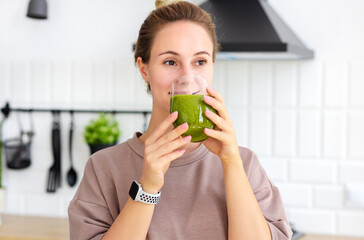 Healthy lifestyle, weight loss concept. Portrait of woman drinking green smoothie close-up. Young...
