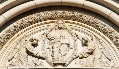 Bremen, Germany - July 13, 2022: Entrance of the Bremer Dom in Germany, Bremen. Beautiful ancient facade with Jesus Christ and other christian ornaments.