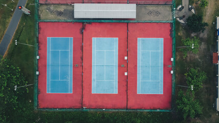 top view of three empty tennis courts