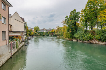Fototapeta premium Bank of the Rhine River passing through Rheinfelden, dividing Switzerland and Germany