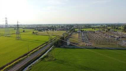 Italy Drone view of Power Plant in Lacchiarella near Milan in the Po Valley- High voltage pylons for the production and transport of energy - energy crisis to increase gas costs and petrol oil energy 