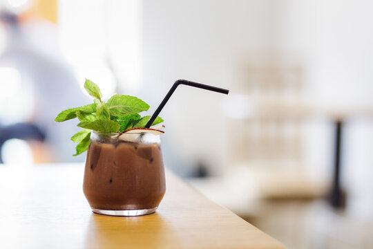 Close-up image of cocoa cocktail with mint on the table