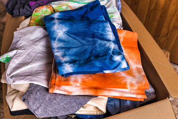 heap of t-shirts. serigraphy production. printing images on tshirts in a design studio. selective focus photo