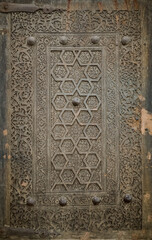 Close-up image of ancient doors with oriental ornaments - obrazy, fototapety, plakaty