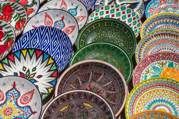 Decorative ceramic plates with traditional uzbek ornament in the street market of Bukhara....